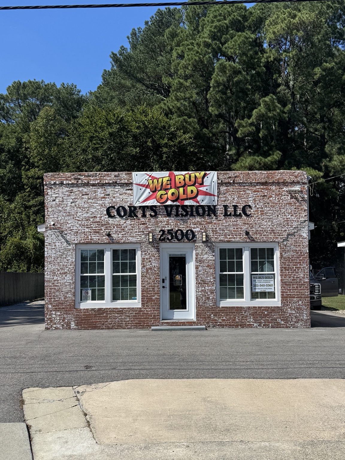 Brick Corts storefront at 2500 South Church Street with We Buy Gold sign